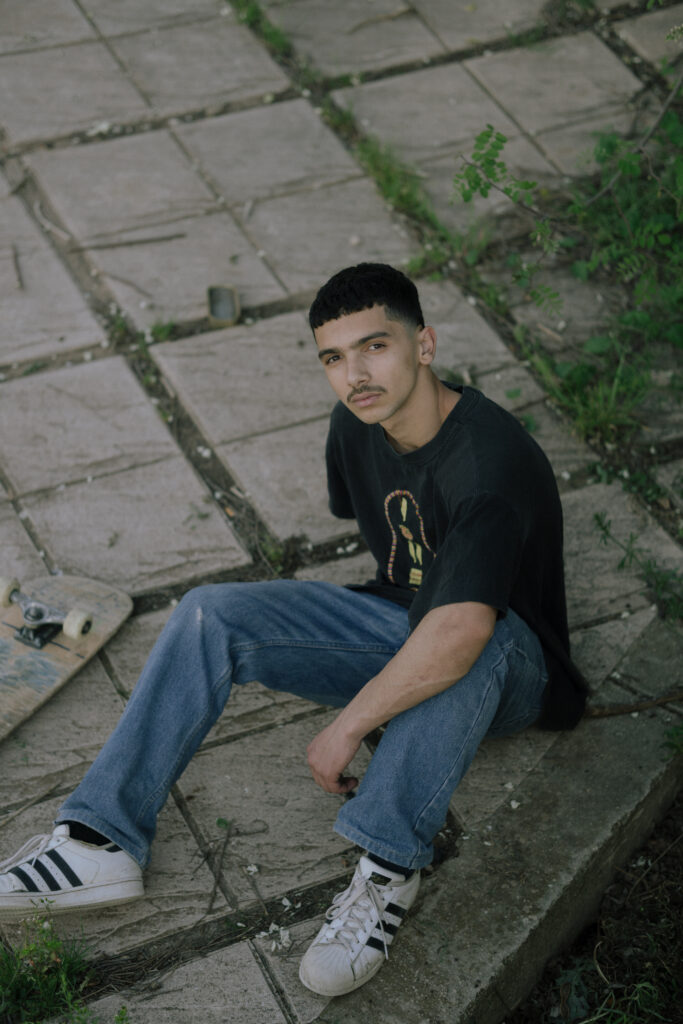 a man setting down with his skate